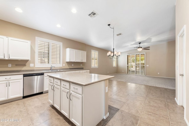 kitchen with sink, a kitchen island, stainless steel dishwasher, white cabinets, and ceiling fan with notable chandelier