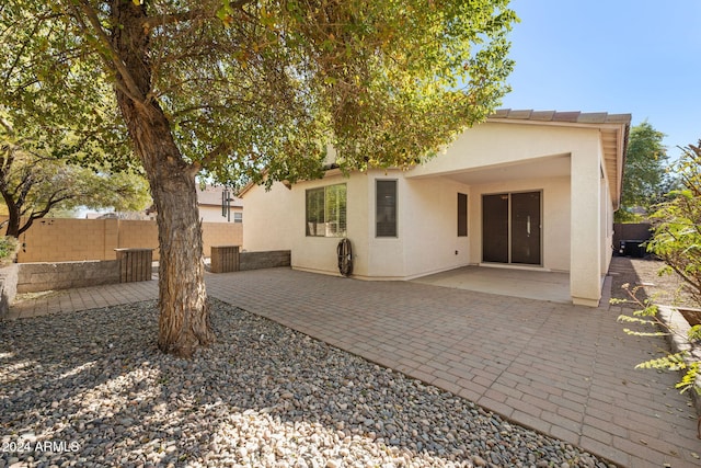 rear view of property featuring a patio area