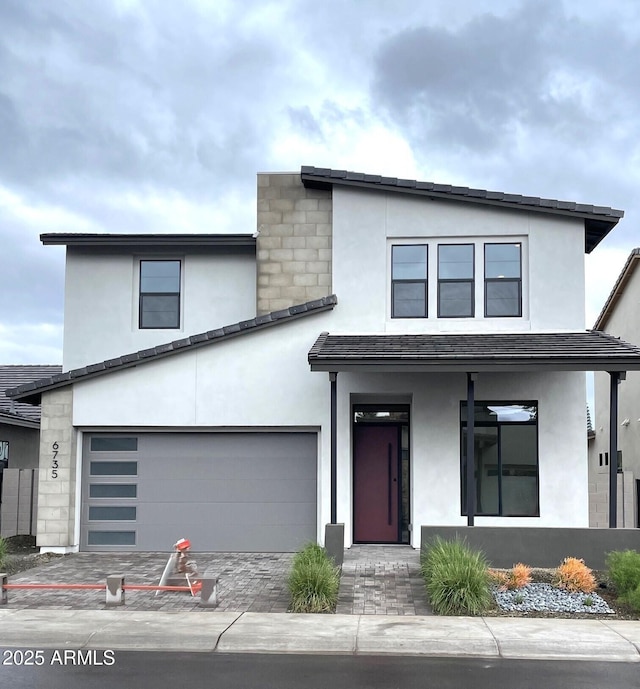 modern home with an attached garage and stucco siding