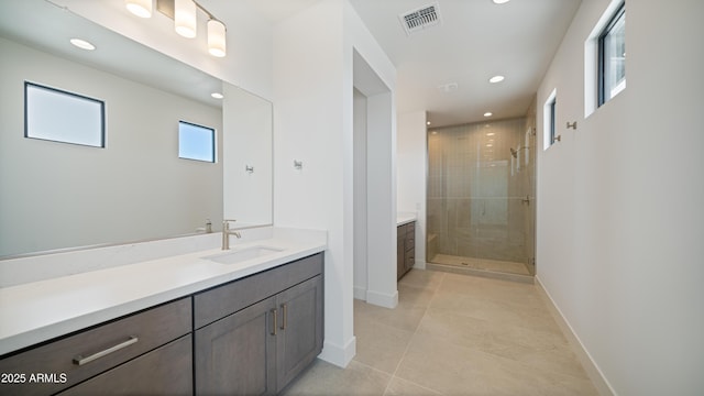 full bath featuring visible vents, recessed lighting, a shower stall, baseboards, and vanity