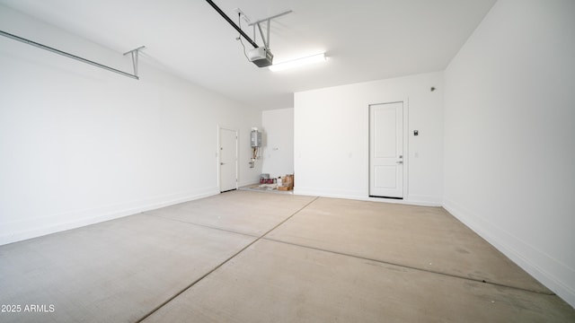 garage with baseboards and a garage door opener