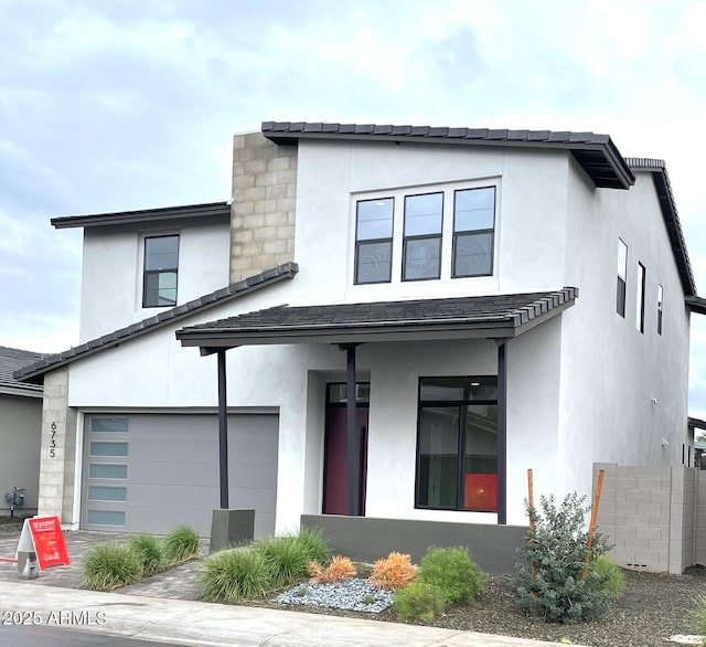 view of front of house featuring a garage and stucco siding