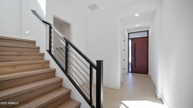 staircase with tile patterned flooring, visible vents, recessed lighting, and baseboards