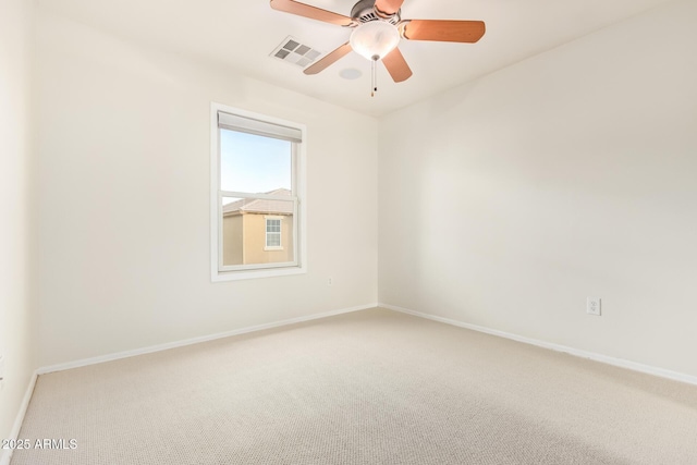 carpeted spare room with ceiling fan