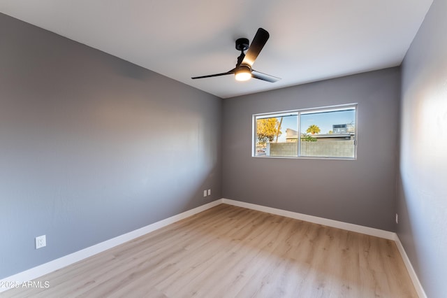 spare room with ceiling fan and light wood-type flooring