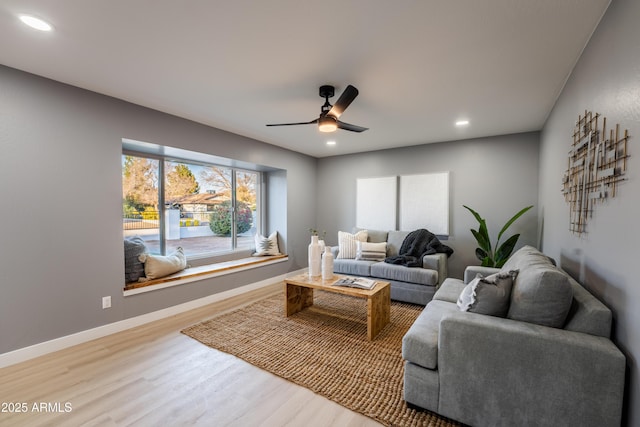 living room with hardwood / wood-style flooring and ceiling fan