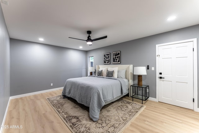 bedroom with light hardwood / wood-style floors and ceiling fan