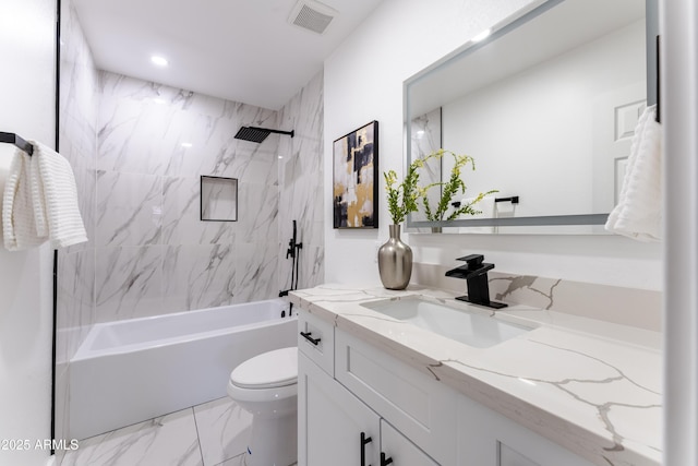 full bathroom with vanity, tiled shower / bath, and toilet