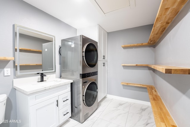 clothes washing area with sink and stacked washer and clothes dryer