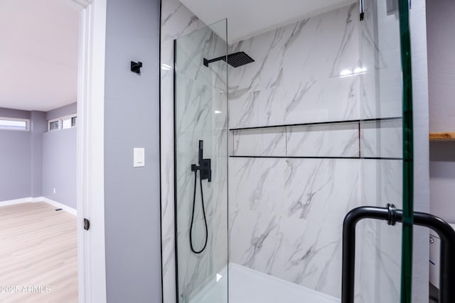 bathroom featuring an enclosed shower and hardwood / wood-style floors