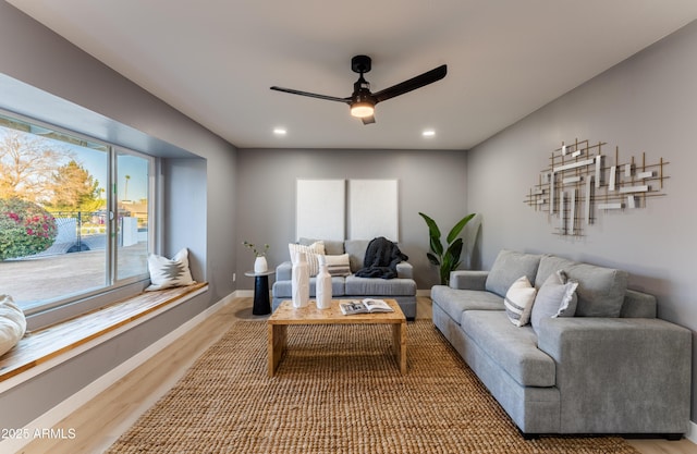 living room featuring ceiling fan and wood-type flooring