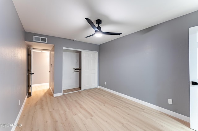 unfurnished bedroom with light hardwood / wood-style floors, ceiling fan, and a closet