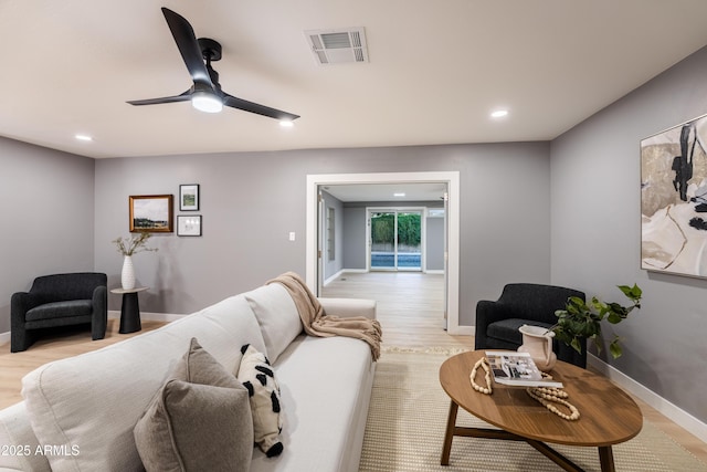 living room with ceiling fan and light wood-type flooring