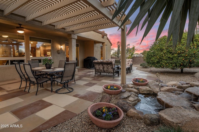 patio terrace at dusk featuring a grill and a pergola