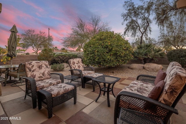 patio terrace at dusk featuring an outdoor living space