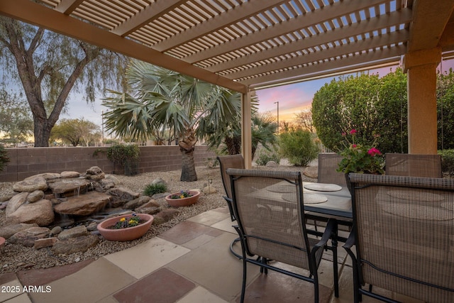 patio terrace at dusk with a pergola