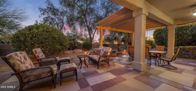 patio terrace at dusk featuring a pergola