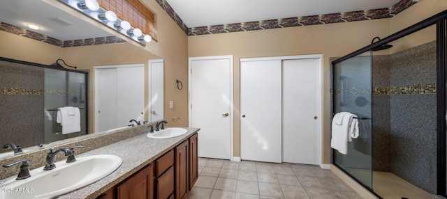 bathroom with tile patterned floors, vanity, and a shower with shower door