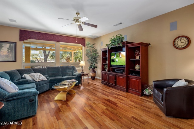 living room with wood-type flooring and ceiling fan