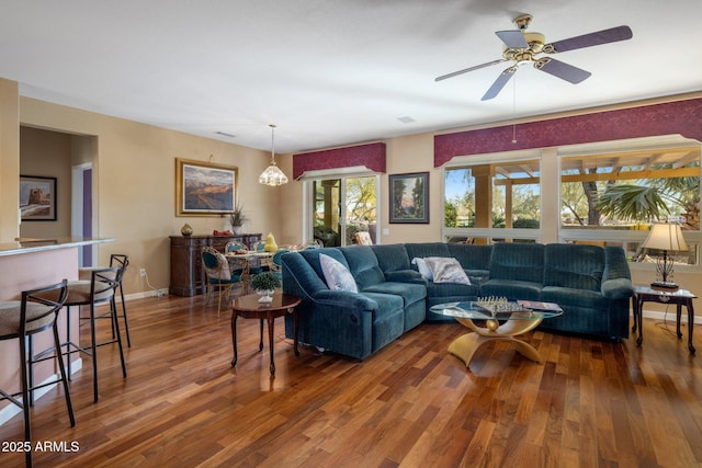 living room featuring dark hardwood / wood-style floors and ceiling fan