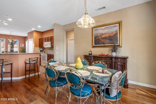 dining area with hardwood / wood-style flooring