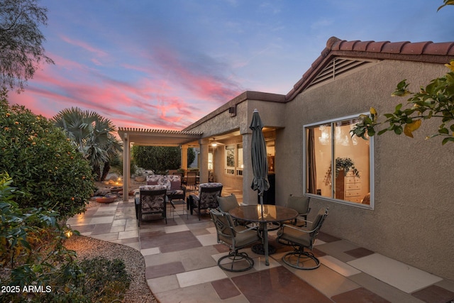 patio terrace at dusk featuring a pergola