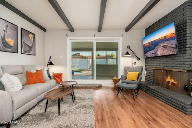 8431 E Rose Ln, Scottsdale, AZ 85250 - living room featuring a fireplace, beam ceiling, and wood finished floors