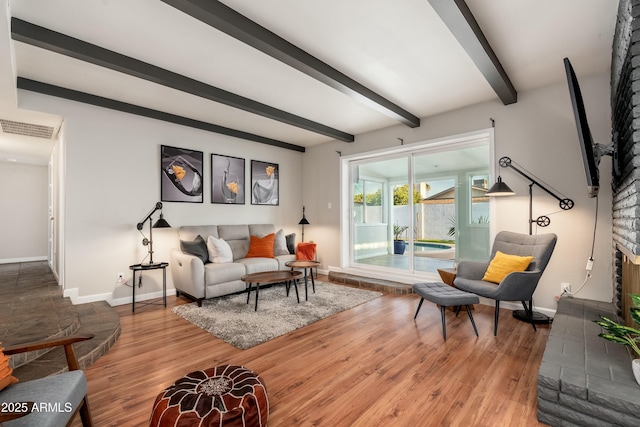 8431 E Rose Ln, Scottsdale, AZ 85250 - living area featuring visible vents, beam ceiling, baseboards, and wood finished floors