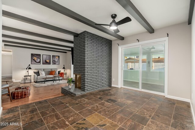 8431 E Rose Ln, Scottsdale, AZ 85250 - living area with stone finish floor, baseboards, a ceiling fan, and beam ceiling