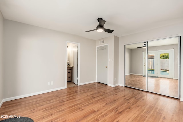 8431 E Rose Ln, Scottsdale, AZ 85250 - unfurnished bedroom featuring access to outside, light wood-style floors, baseboards, and visible vents