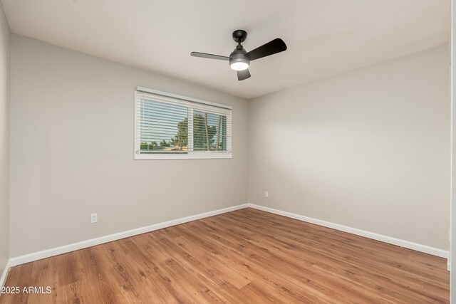 8431 E Rose Ln, Scottsdale, AZ 85250 - empty room with light wood-style floors, baseboards, and a ceiling fan