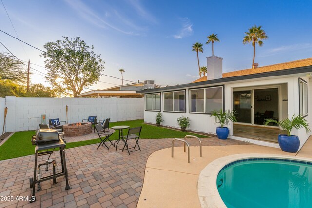 8431 E Rose Ln, Scottsdale, AZ 85250 - view of pool with fence private yard, a lawn, a patio, a fire pit, and a fenced in pool