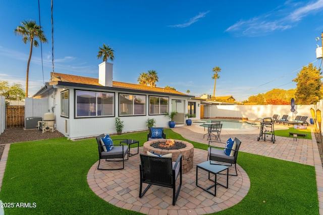 8431 E Rose Ln, Scottsdale, AZ 85250 - back of property with a fire pit, a chimney, a fenced backyard, a patio, and a fenced in pool