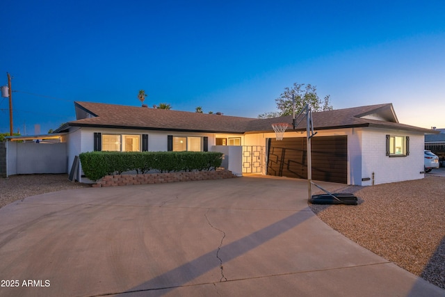 8431 E Rose Ln, Scottsdale, AZ 85250 - ranch-style home with roof with shingles, brick siding, a gate, a garage, and driveway