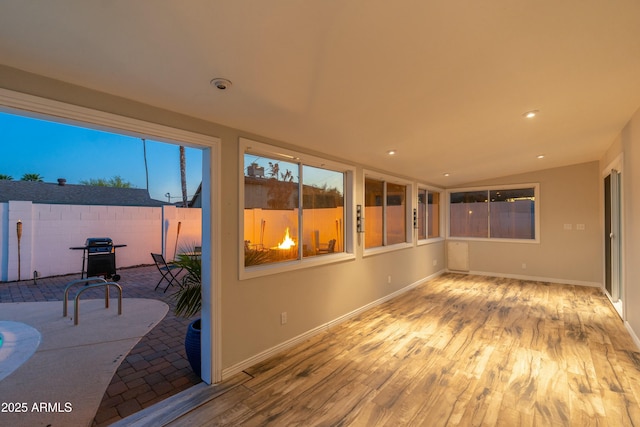 8431 E Rose Ln, Scottsdale, AZ 85250 - unfurnished sunroom with recessed lighting, lofted ceiling, baseboards, and wood finished floors
