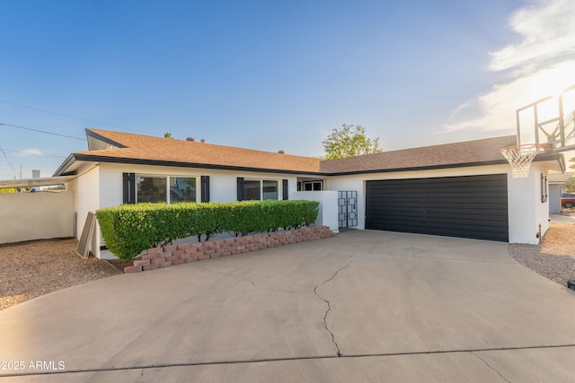 8431 E Rose Ln, Scottsdale, AZ 85250 - ranch-style house featuring an attached garage, a shingled roof, and driveway