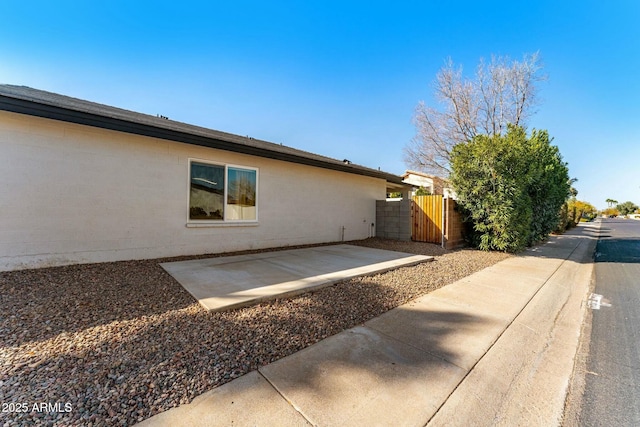 view of side of home featuring a patio