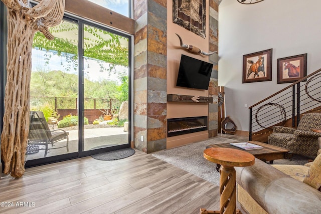 living room featuring a high ceiling and light wood-type flooring