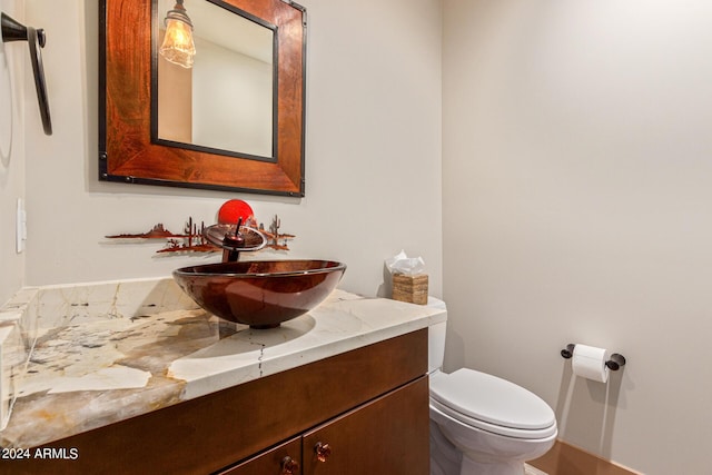 bathroom featuring vanity and toilet