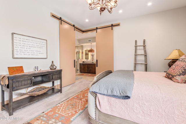 carpeted bedroom with a barn door, ensuite bath, and a chandelier