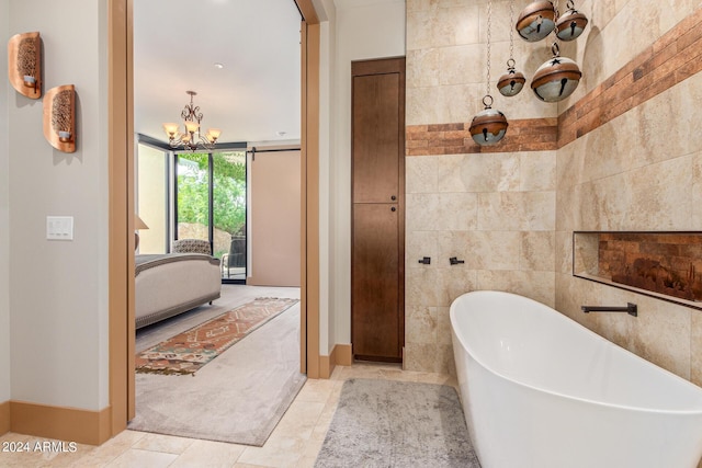 bathroom with a bathing tub, tile walls, tile patterned floors, and a chandelier