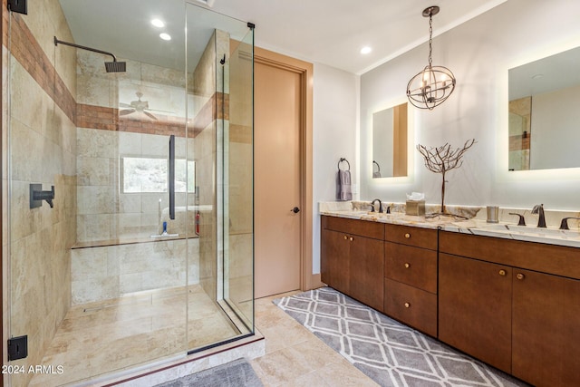 bathroom featuring ceiling fan with notable chandelier, vanity, walk in shower, and tile patterned flooring