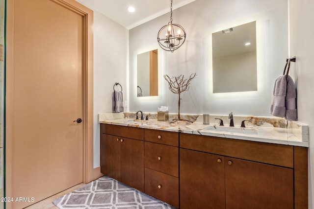 bathroom with a notable chandelier and vanity