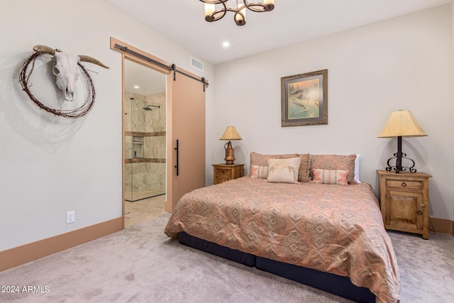 carpeted bedroom with a barn door, connected bathroom, and an inviting chandelier