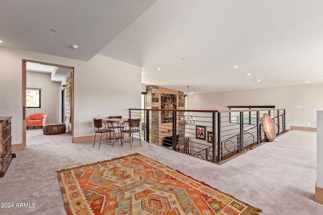 hall featuring plenty of natural light and light colored carpet