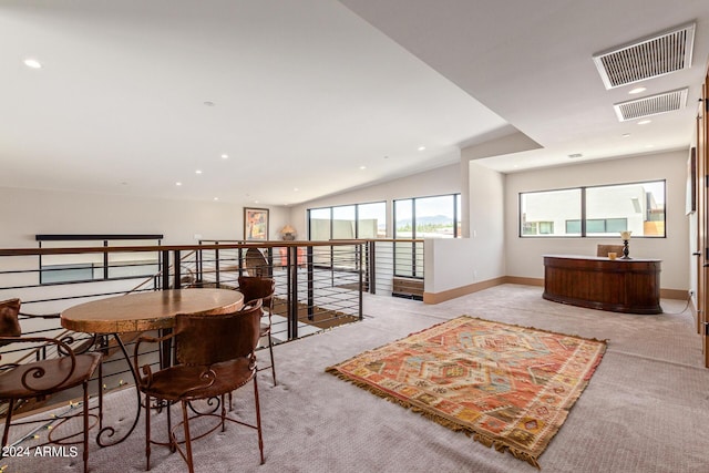 interior space with light carpet and lofted ceiling