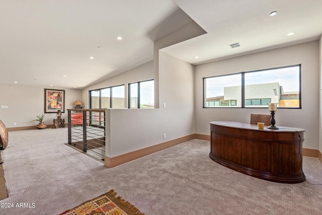 office space featuring light colored carpet and vaulted ceiling