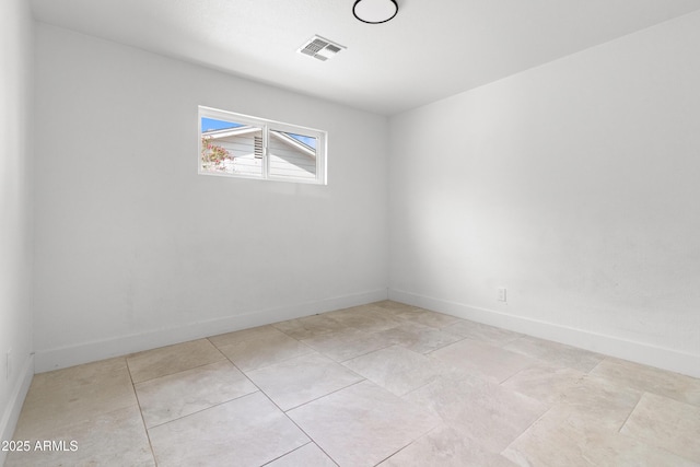 spare room with baseboards