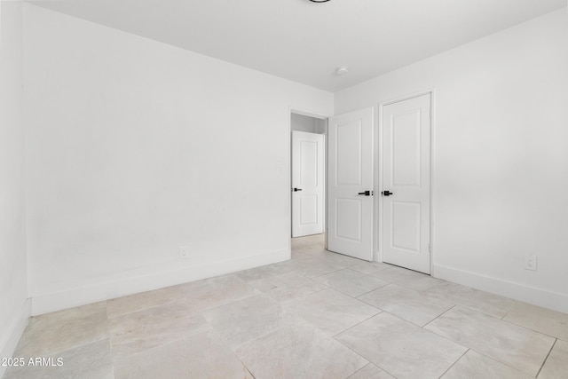 unfurnished bedroom featuring baseboards