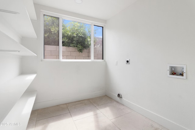 washroom with washer hookup, hookup for an electric dryer, baseboards, and tile patterned flooring